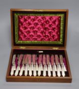 A cased set of twelve pairs of mother of pearl handled silver dessert eaters, Walker & Hall,