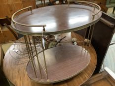 A brass mounted simulated rosewood oval two tier tea trolley, c.1970, width 70cm depth 45cm height
