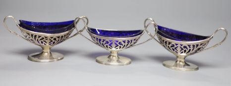 A matched set of three George III pierced silver salts with blue glass liners, London, 1788 and