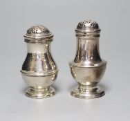 Two 18th century silver peppers, London, 1723 and London, 1757, the latter a.f.,tallest 88mm.
