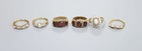 A suite of three opal and 9ct gold rings and three other 9ct gold gem-set rings,gross 17.9 grams.