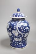 A 20th century Chinese blue and white jar and cover with prunus decoration, height 25cm