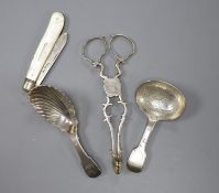 A pair of 18th century silver sugar nips, two later silver caddy spoons and a mother of pearl and