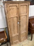 A Victorian panelled pitched pine two door cabinet, width 108cm depth 40cm height 198cm