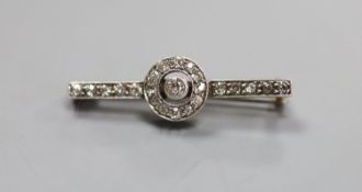 An early 20th century white metal (stamped 9ct) and diamond target cluster set bar brooch,31mm,