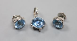 A modern pair of white metal, aquamarine and diamond set ear studs and a matching pendant,pendant