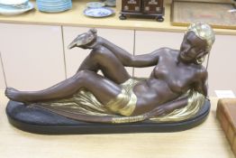 An Art Deco style painted plaster reclining nude holding a dove, length 75cm