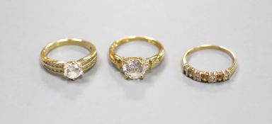 An 18ct gold paste-set solitaire ring, a similar 14ct gold ring and a 9ct gold, diamond and gem-set