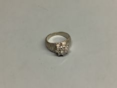 A modern textured white metal and diamond cluster set dress ring,size F, gross 5 grams.