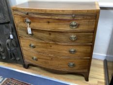 A Regency mahogany satinwood banded bow-fronted chest, fitted brushing slide and four drawers on