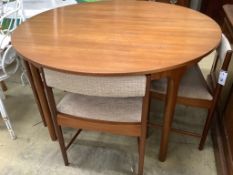 A mid century design Macintosh circular teak extending dining table and four chairs, model 9533,