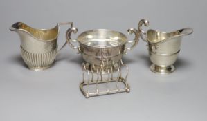 An Edwardian silver cream jug and sugar bowl, Birmingham, 1909, a demi fluted silver cream jug and