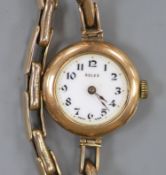 A lady's early 20th century 9ct gold Rolex manual wind wrist watch, on a 9ct flexible bracelet (no