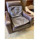 An Italian brown leather swivel armchair and two cushions, width 78cm, depth 80cm, height 91cm