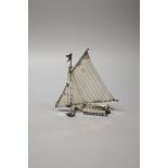 A continental miniature white metal and enamel model of an ice yacht, height 12.5cm, gross 85