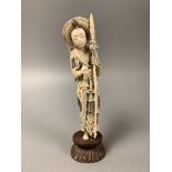 A Chinese ivory figure of Hua Mulan, early 20th century, height 26cm including wood stand