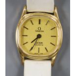 A lady's steel and gold plated Omega De Ville quartz wrist watch, on an associated leather strap.