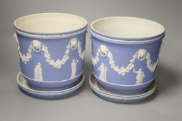 A pair of Victorian Wedgwood blue ground jasperware jardinieres and stands,decorated with swags and