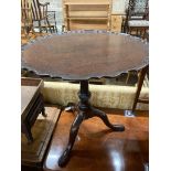 A George III style mahogany circular tripod table (later carved), 73cm diameter, height 70cm