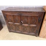 A 17th century carved and panelled oak cupboardenclosed by a pair of doors, length 139cm, depth