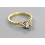 A modern 18ct gold and solitaire diamond ring,size M, gross 2.9 grams, the stone weighing