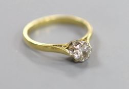 A modern 18ct gold and solitaire diamond ring,size M, gross 2.9 grams, the stone weighing