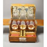 A good Victorian oak and brass mounted tantalus and combination games box, height 35.5cm width 36cm