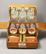 A good Victorian oak and brass mounted tantalus and combination games box, height 35.5cm width 36cm