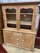 A Victorian pine dresserenclosed by a pair of glazed doors over cupboards and drawers, width 146cm,