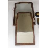 Two walnut-framed wall mirrors