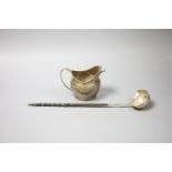 A George III silver cream jug, London, 1802 (a.f.)9.5cm and a 19th century white metal toddy ladle,