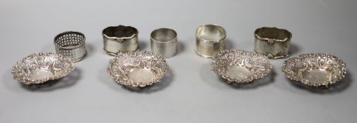 A pair of Edwardian silver napkin rings, London, 1906, three others and four pierced silver bonbon
