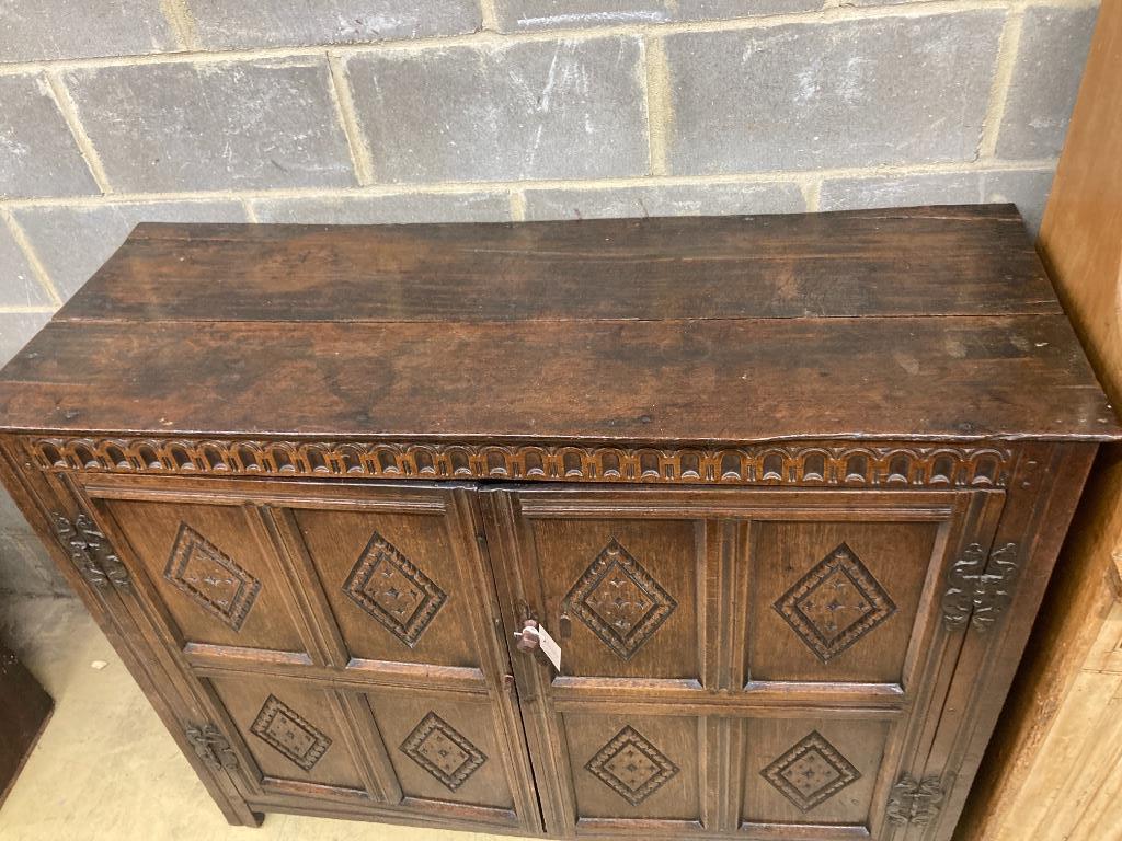 A 17th century carved and panelled oak cupboardenclosed by a pair of doors, length 139cm, depth - Image 2 of 3