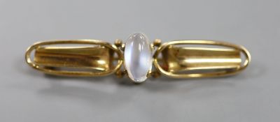 An early 20th century Arts & Crafts 9ct and cabochon moonstone set bar brooch,