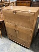 An Ercol elm fall front cabinet, width 82cm depth 44cm height 110cm