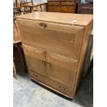 An Ercol elm fall front cabinet, width 82cm depth 44cm height 110cm