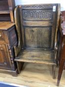 An 18th century style narrow oak panelled wing back settle, width 66cm, depth 46cm, height 115cm