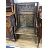 An 18th century style narrow oak panelled wing back settle, width 66cm, depth 46cm, height 115cm