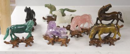 Eight Chinese 20th century carved hardstone 'Horses of Mu Wang'on hardwood stands