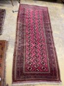 A Tekke Bokhara red ground rug, 254 x 109cm, together with a machined rug