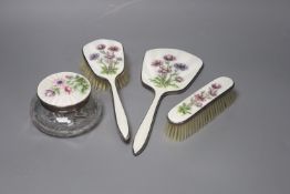 A four-piece silver plated and enamel dressing table set