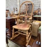 A reproduction beech Windsor rocking chair, width 63cm, depth 52cm, height 110cm