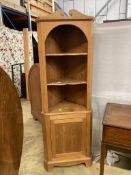 A pine standing corner cabinet, height 180cm