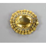A late Victorian yellow metal and citrine set oval brooch, with canetile work decoration,38mm,