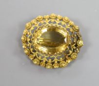 A late Victorian yellow metal and citrine set oval brooch, with canetile work decoration,38mm,