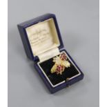 A 1970's 18ct gold, ruby and diamond quadruple cluster dress ring, by Ben Rosenfeld,size O, gross