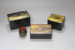 Three Russian lacquer ‘troika’ boxes, largest 13.5cm and a napkin ring