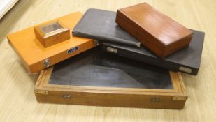 A glass table top cabinet and a collection of pen boxes