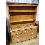 A Victorian pine dresserhaving boarded plate rack over three short drawers and three graduated long