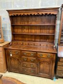 A reproduction 18th century style oak dresser, width 152cm, depth 54cm, height 198cm